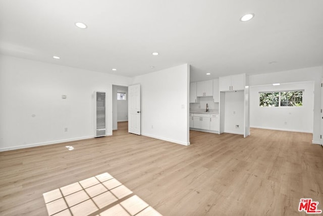 unfurnished living room with light wood-type flooring