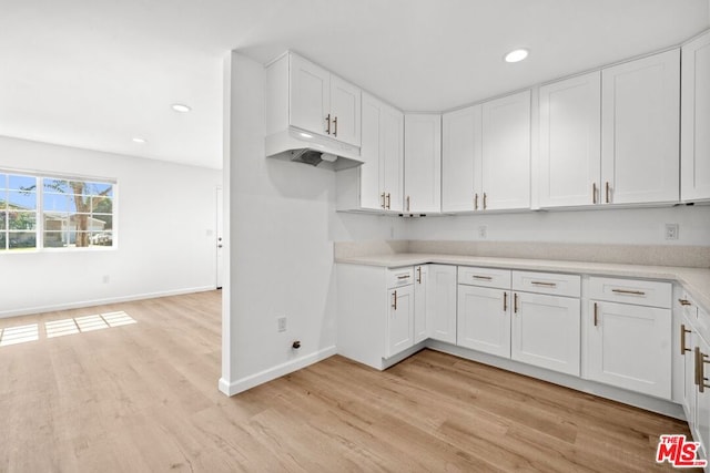 kitchen with white cabinetry and light hardwood / wood-style flooring