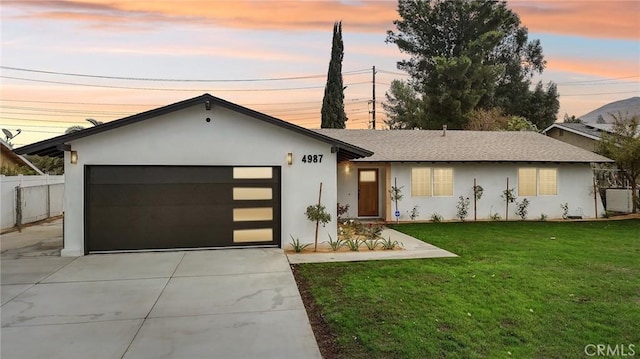 view of front of house with a yard and a garage