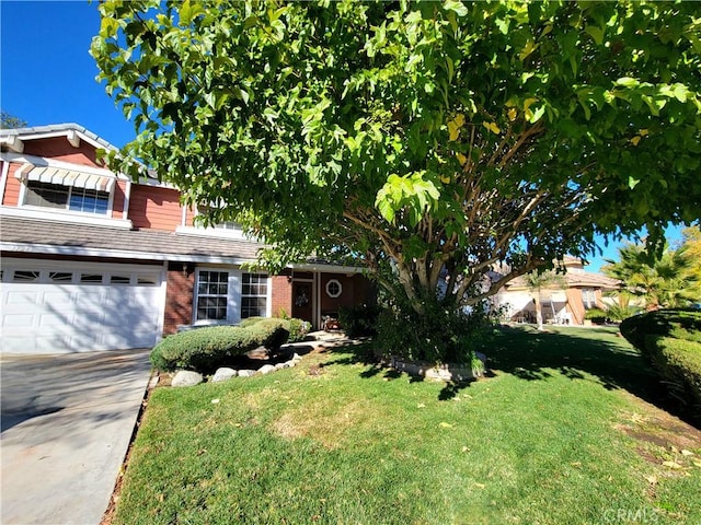 view of front of property featuring a garage and a front lawn