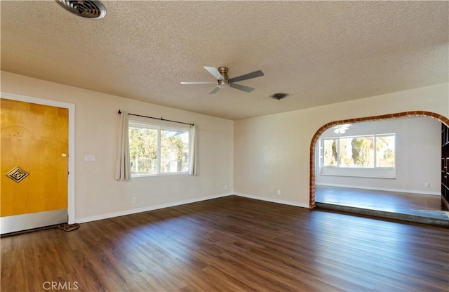 interior space with a textured ceiling, dark hardwood / wood-style flooring, and ceiling fan