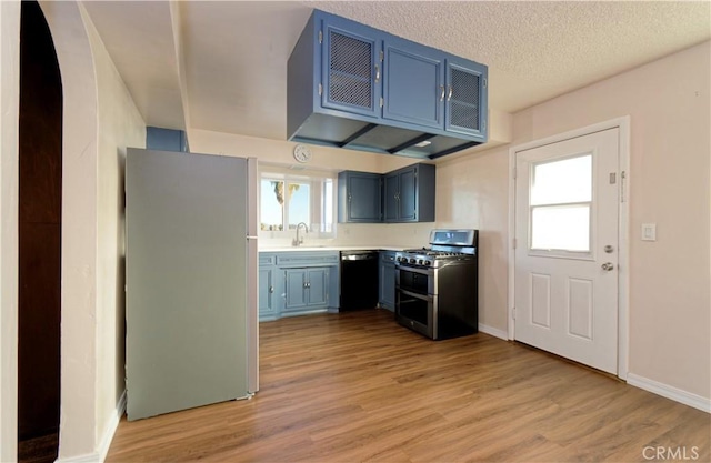 kitchen with plenty of natural light, white fridge, range with two ovens, and black dishwasher