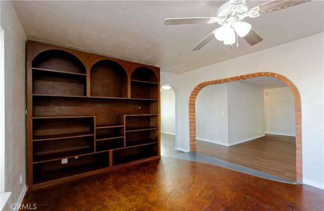 spare room featuring ceiling fan, dark hardwood / wood-style flooring, and built in features