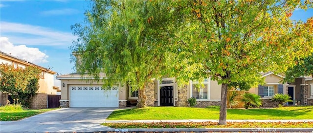 obstructed view of property featuring a garage and a front lawn