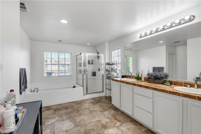 bathroom featuring vanity and plus walk in shower