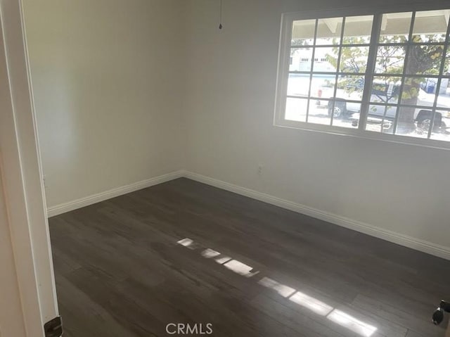 empty room with dark hardwood / wood-style floors