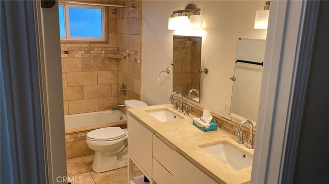 full bathroom featuring vanity, tile patterned flooring, tiled shower / bath, and toilet