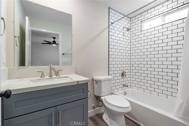 full bathroom with ceiling fan, toilet, shower / tub combo with curtain, vanity, and hardwood / wood-style flooring