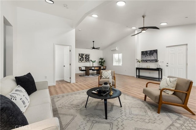 living room with ceiling fan, high vaulted ceiling, and light wood-type flooring