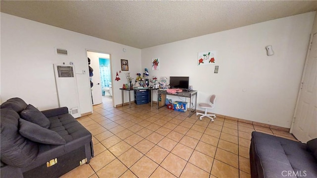 tiled living room featuring a textured ceiling