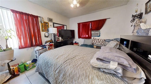 tiled bedroom with a textured ceiling and cooling unit