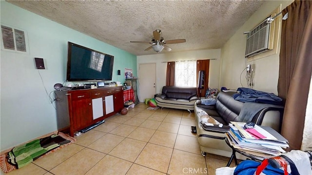 living room featuring ceiling fan, light tile patterned floors, a textured ceiling, and an AC wall unit