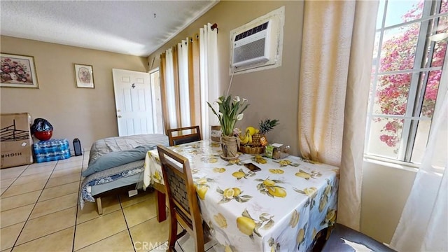 dining room featuring light tile patterned flooring and a wall unit AC