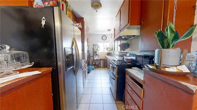 kitchen with appliances with stainless steel finishes and light tile patterned flooring