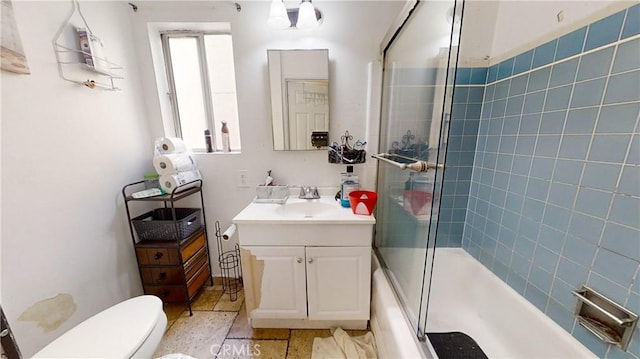 full bathroom with vanity, toilet, and bath / shower combo with glass door