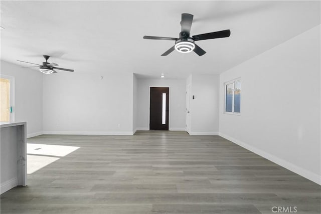 unfurnished living room with ceiling fan and light wood-type flooring