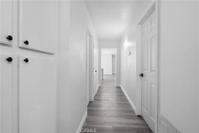 hallway with hardwood / wood-style floors