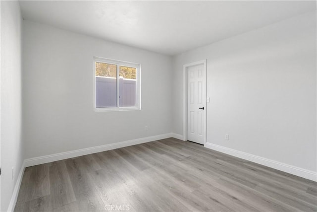 unfurnished room with light hardwood / wood-style flooring