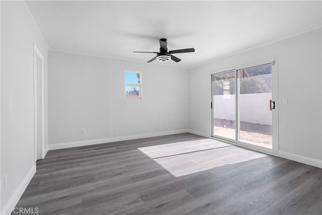 spare room with dark hardwood / wood-style flooring, ceiling fan, and ornamental molding