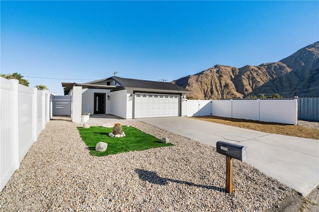 ranch-style house with a mountain view and a garage