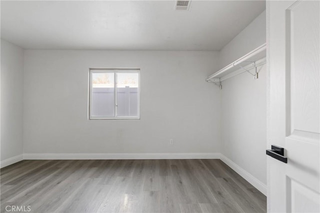 spacious closet with light hardwood / wood-style floors