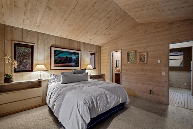 carpeted bedroom with ensuite bathroom, wood walls, wooden ceiling, and vaulted ceiling