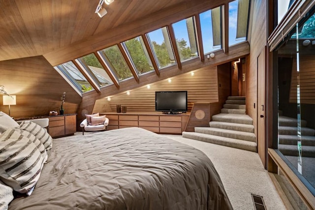 carpeted bedroom with high vaulted ceiling, wood walls, and wood ceiling