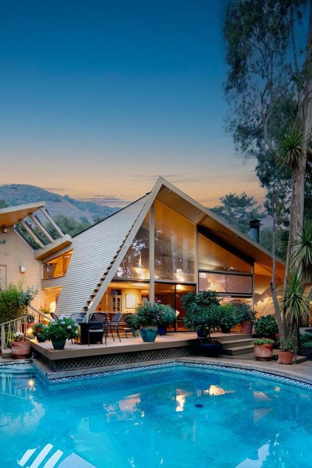 pool at dusk with a mountain view