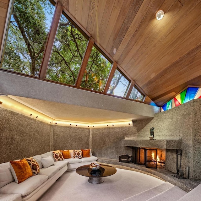 unfurnished living room featuring rail lighting, wooden ceiling, an outdoor fireplace, and high vaulted ceiling