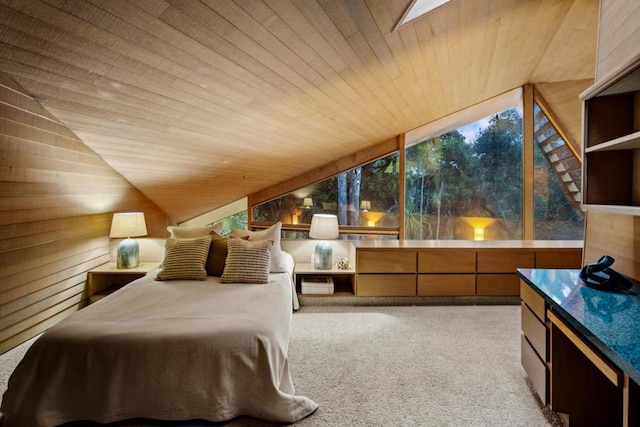 carpeted bedroom with wooden walls, wooden ceiling, and vaulted ceiling with skylight