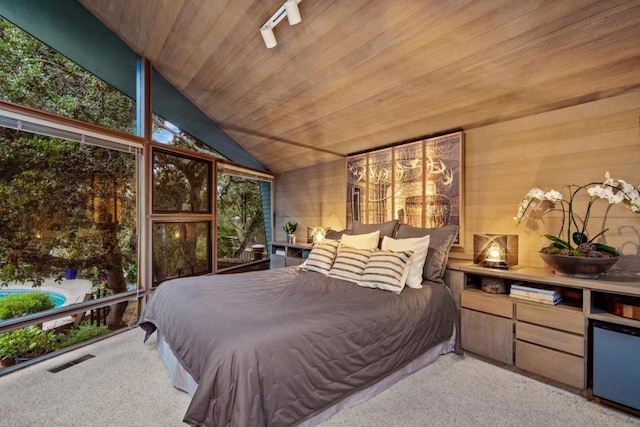 carpeted bedroom featuring lofted ceiling and wood ceiling