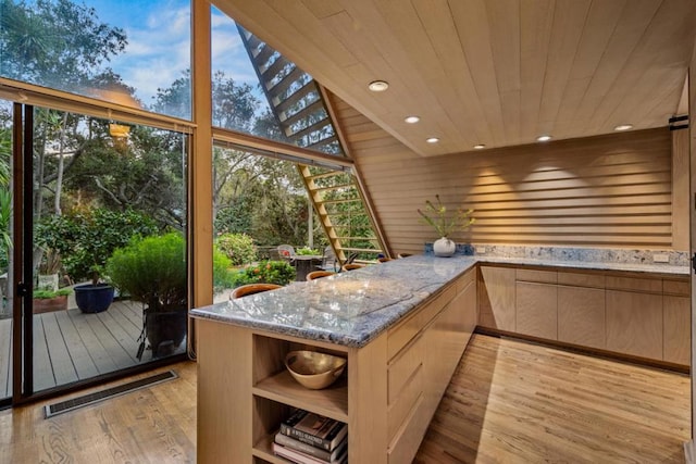 sunroom with wooden ceiling and a healthy amount of sunlight