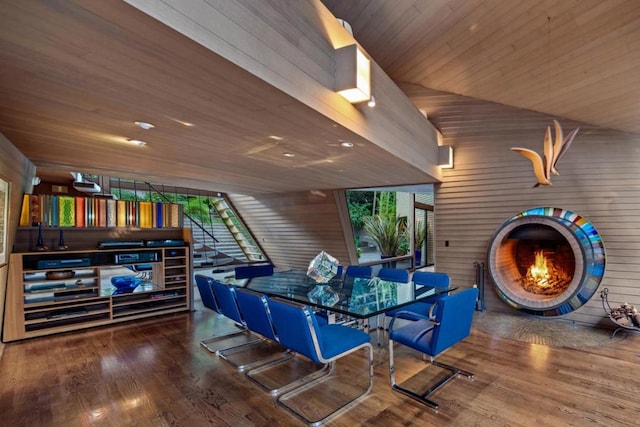 dining room featuring wood walls, wood-type flooring, and wood ceiling