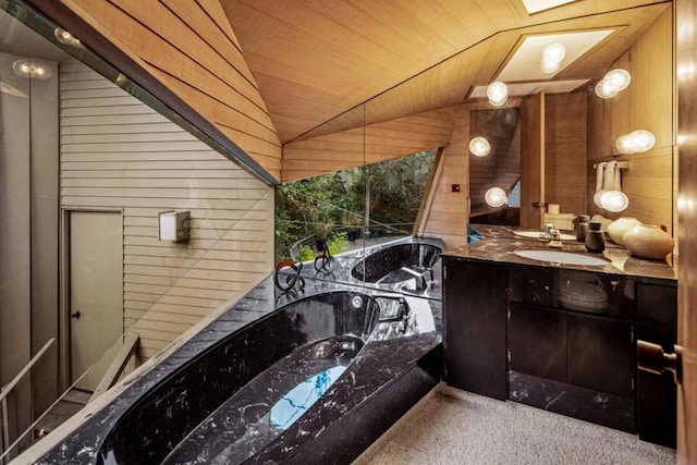 bathroom with a bathing tub, lofted ceiling, wooden walls, vanity, and wood ceiling