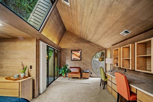 office area with a healthy amount of sunlight, built in desk, vaulted ceiling, and wooden ceiling