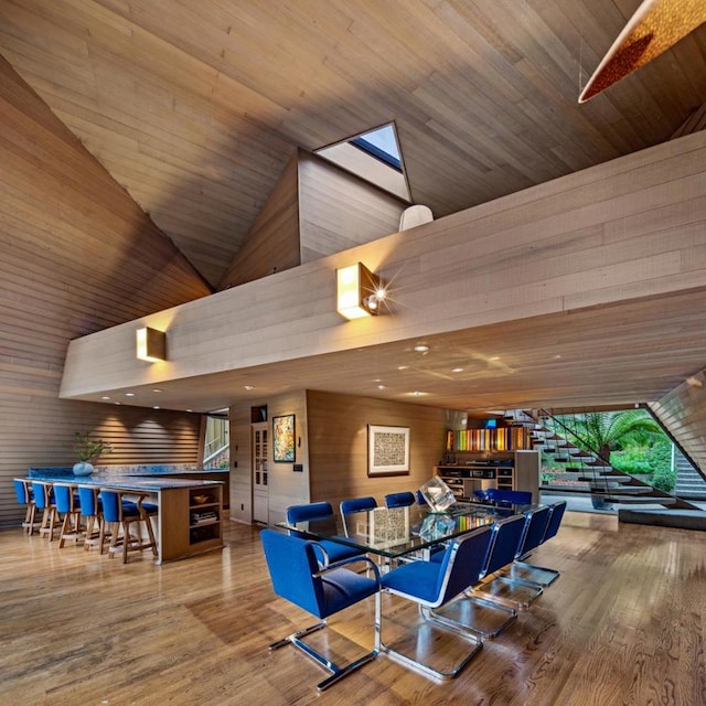 playroom featuring wooden walls, high vaulted ceiling, wooden ceiling, and hardwood / wood-style flooring