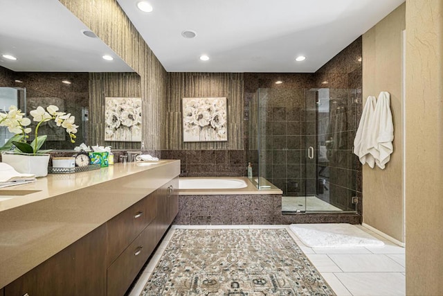 bathroom with tile patterned flooring, vanity, and separate shower and tub