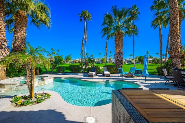 view of swimming pool featuring an in ground hot tub and a patio