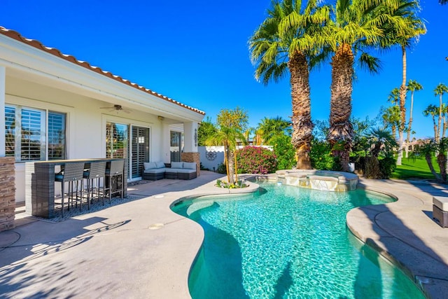 view of swimming pool featuring an in ground hot tub, ceiling fan, an outdoor living space, exterior bar, and a patio