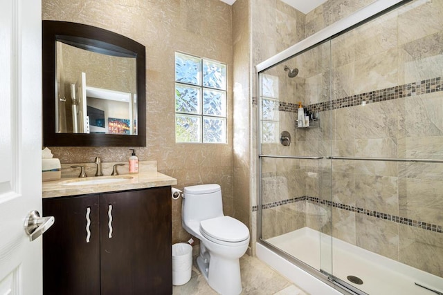 bathroom with vanity, a shower with shower door, and toilet