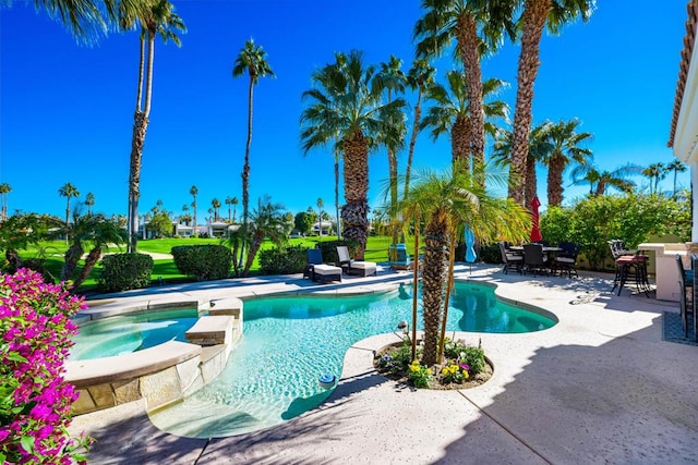 view of swimming pool with an in ground hot tub and a patio