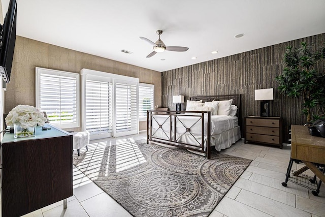 tiled bedroom with ceiling fan, access to exterior, and wooden walls