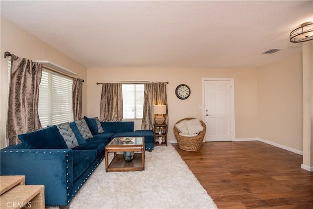 living room featuring dark hardwood / wood-style flooring and a wealth of natural light