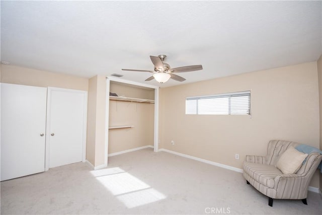 unfurnished room featuring light carpet and ceiling fan