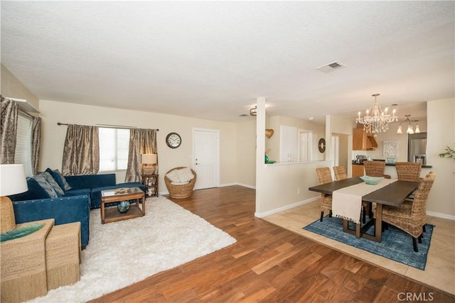 living room featuring hardwood / wood-style flooring and an inviting chandelier