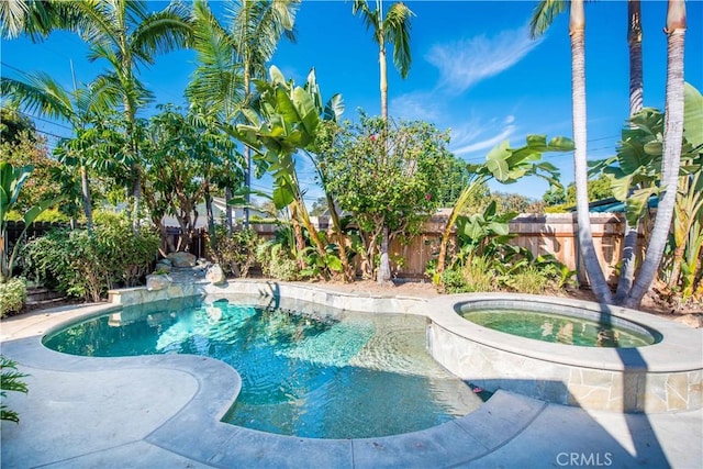 view of swimming pool featuring an in ground hot tub