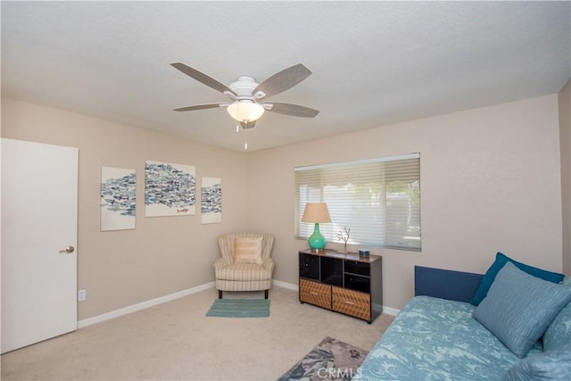 living area featuring ceiling fan and light colored carpet