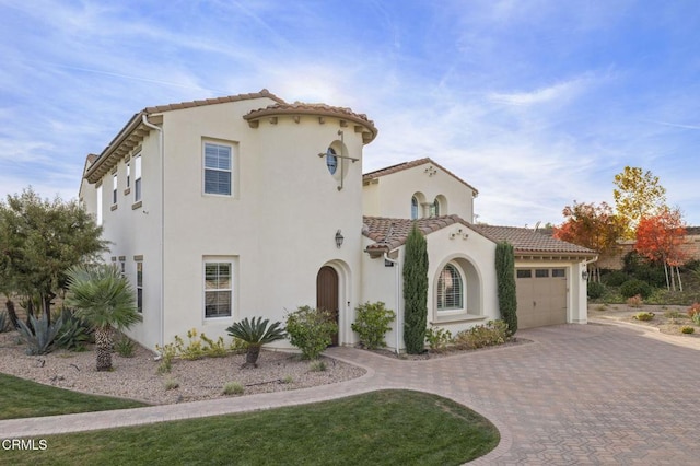 mediterranean / spanish house featuring a garage