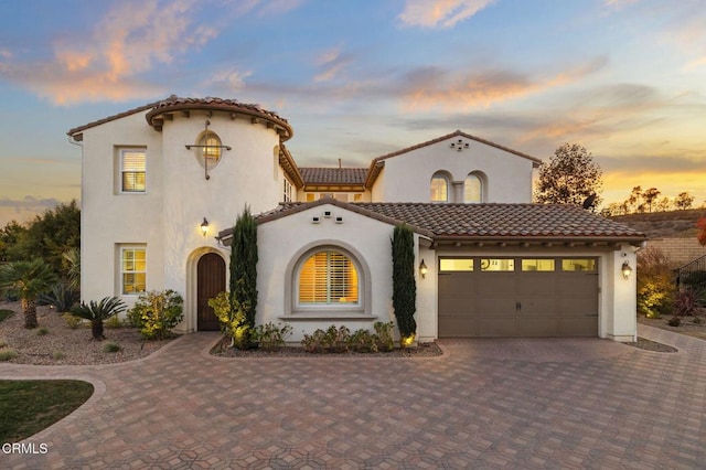 mediterranean / spanish house with a garage