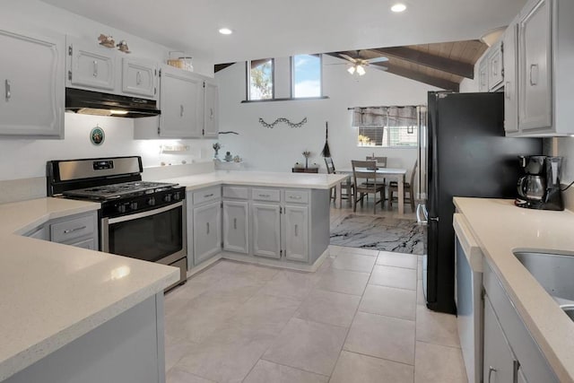 kitchen featuring kitchen peninsula, lofted ceiling with beams, ceiling fan, wooden ceiling, and stainless steel range with gas stovetop